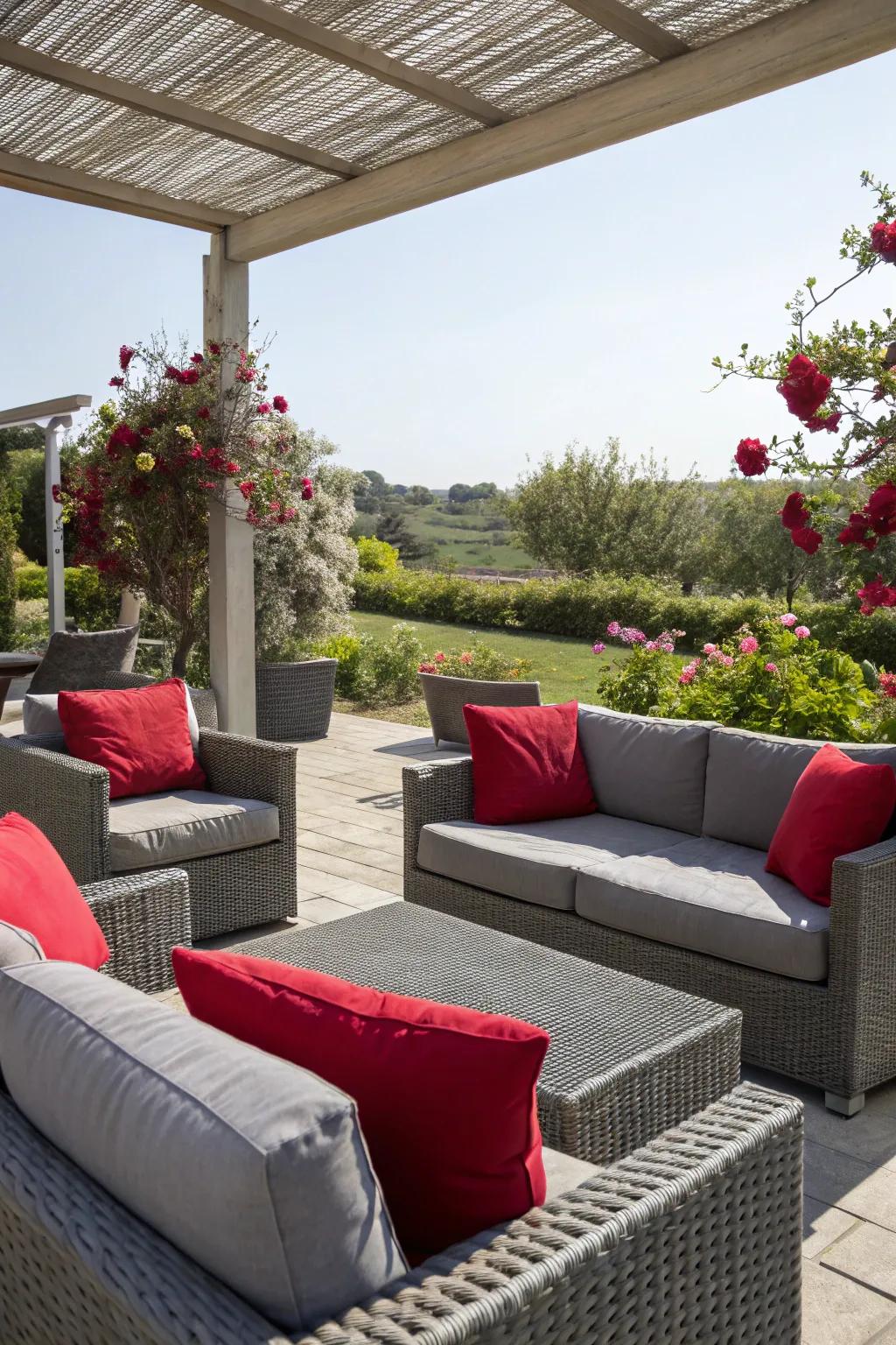 The outdoor space highlights grey furnishings and poppy pillows.
